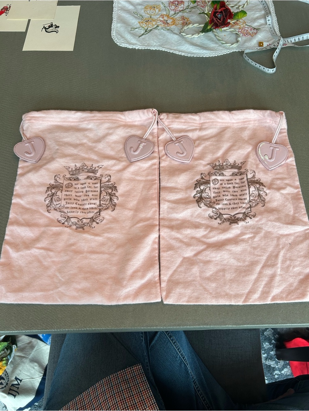 Two Juicy Couture Pink Drawstring dust bags with Heart Pull-Tabs have wear